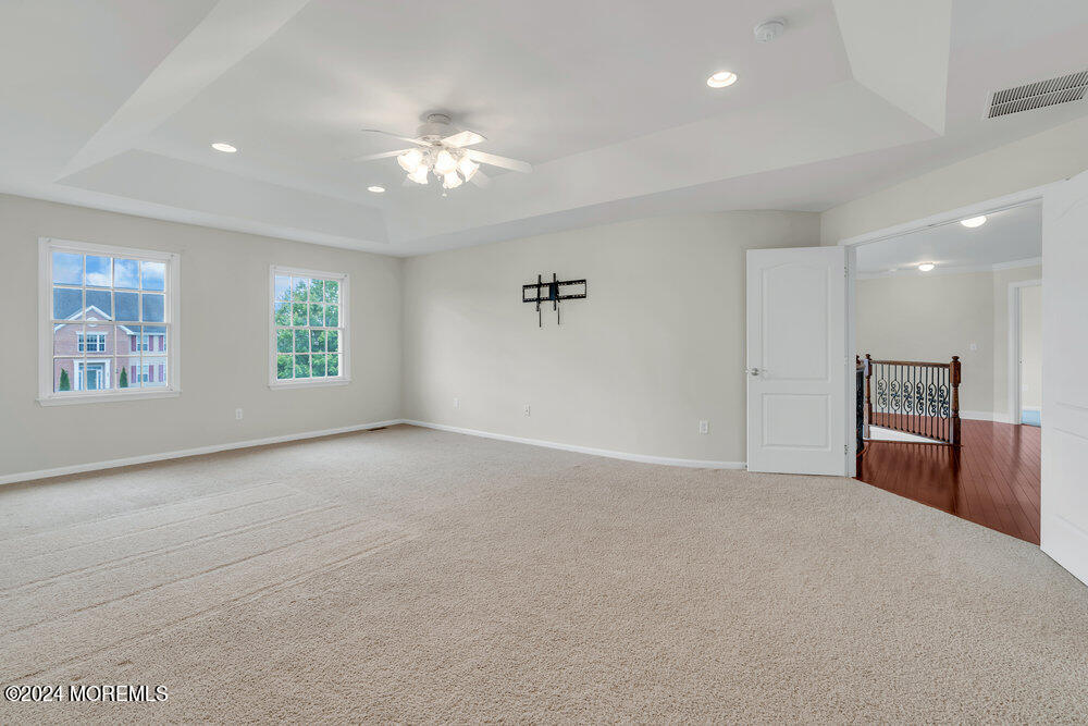 10 Hanging Rock Road Freehold, NJ 07728 - Photo 29 of 61 a view of a livingroom with a ceiling fan window and hardwood
