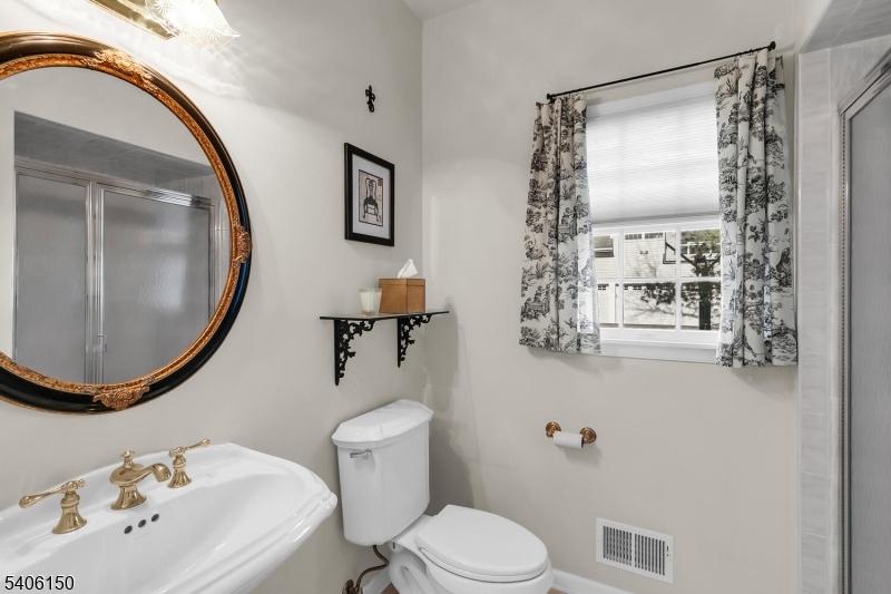 842 Madison Avenue Bridgewater, NJ 08807 - Photo 18 of 50 a bathroom with a sink toilet and mirror