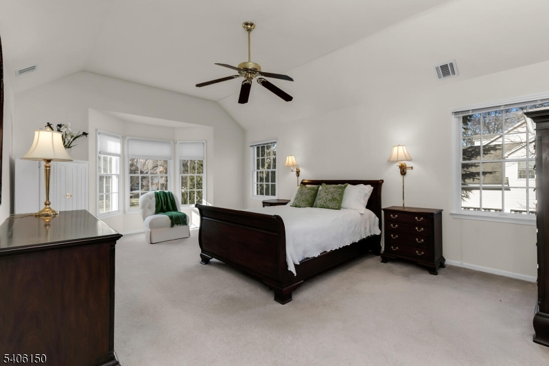 842 Madison Avenue Bridgewater, NJ 08807 - Photo 24 of 50 a spacious bedroom with a bed couch chandelier and a window