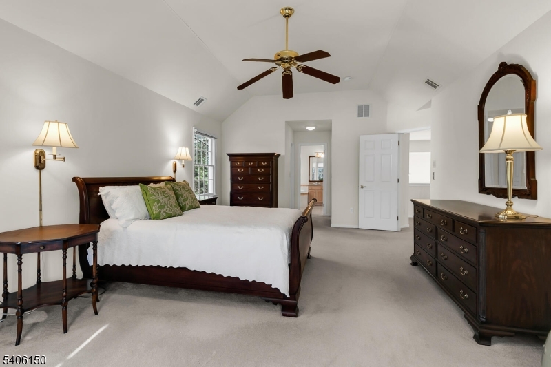 842 Madison Avenue Bridgewater, NJ 08807 - Photo 26 of 50 a spacious bedroom with a bed dresser and a chandelier