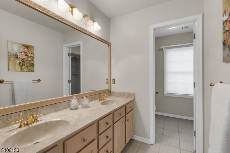 842 Madison Avenue Bridgewater, NJ 08807 - Photo 31 of 50 a bathroom with a double vanity sink and a mirror