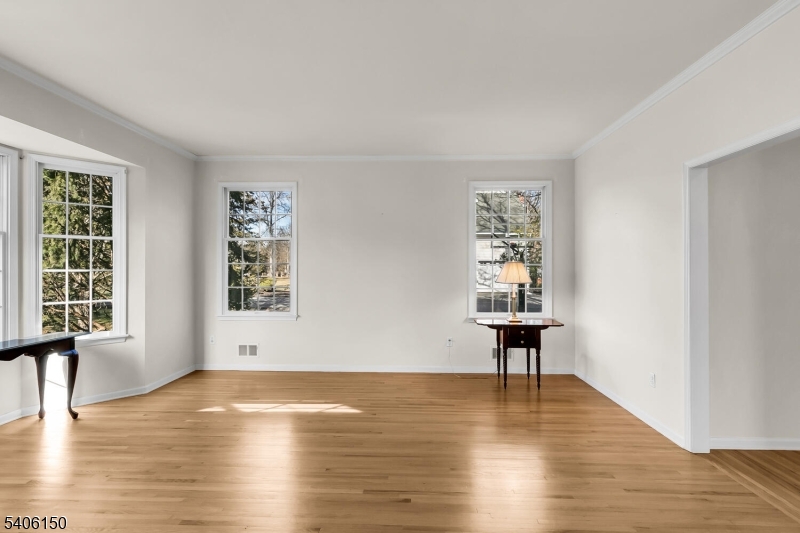 842 Madison Avenue Bridgewater, NJ 08807 - Photo 7 of 50 a view of an empty room with window and wooden floor