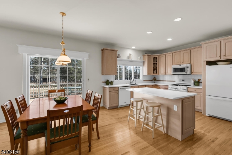 842 Madison Avenue Bridgewater, NJ 08807 - Photo 10 of 50 a kitchen with stainless steel appliances granite countertop a stove a refrigerator a kitchen island a dining table and chairs