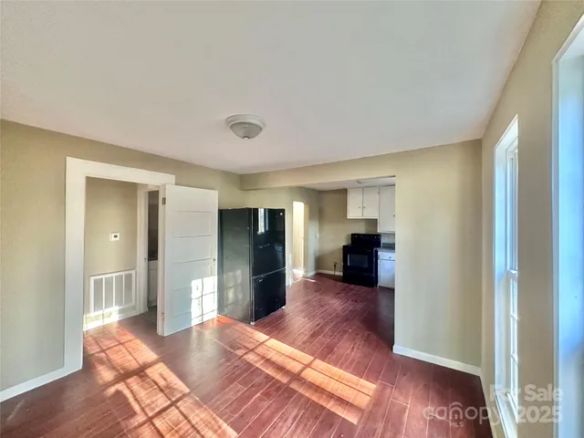 a view of a room with wooden floor and furniture