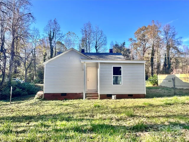 a view of a house with yard and a garden
