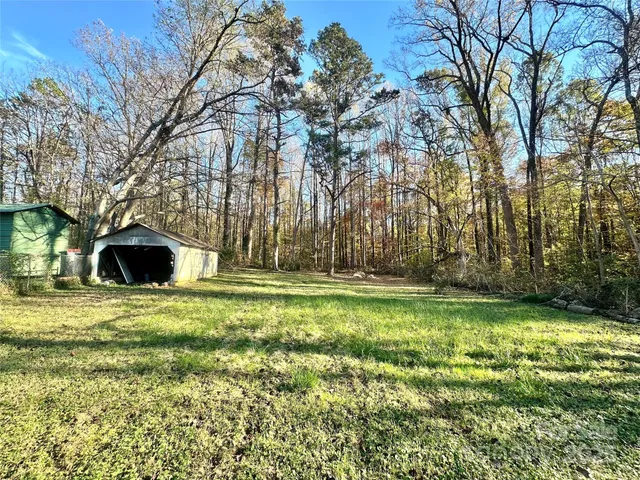 a yellow house in middle of the forest