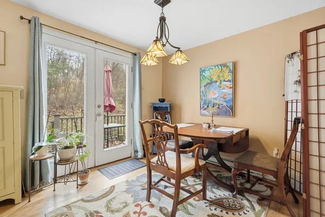 a dining room with furniture a chandelier and wooden floor