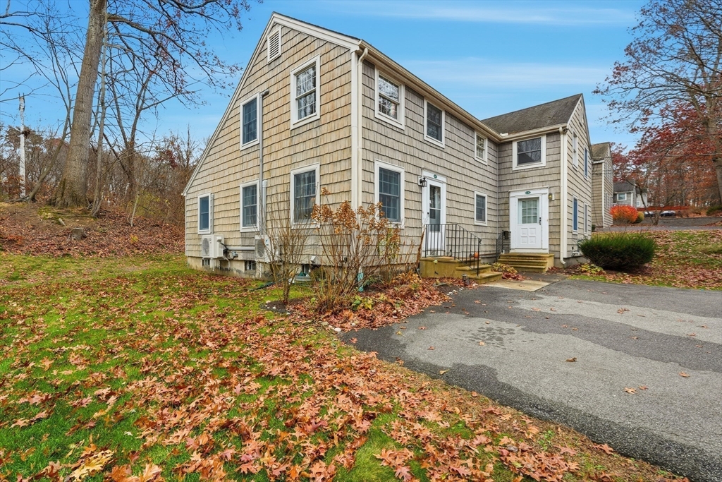58 A Laurel Street, Unit 58A Greenfield, MA 01301 - Photo 2 of 35 a front view of a house with garden