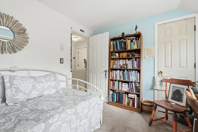 a bedroom with furniture and a book shelf