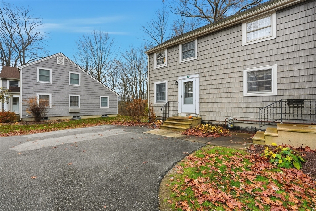 58 A Laurel Street, Unit 58A Greenfield, MA 01301 - Photo 3 of 35 a front view of a house with a yard and garage