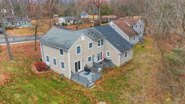 a aerial view of a house with swimming pool and large trees