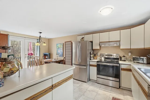 a kitchen with a sink appliances and cabinets