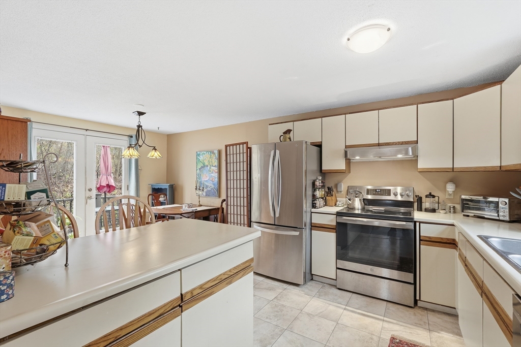 58 A Laurel Street, Unit 58A Greenfield, MA 01301 - Photo 9 of 35 a kitchen with a sink appliances and cabinets
