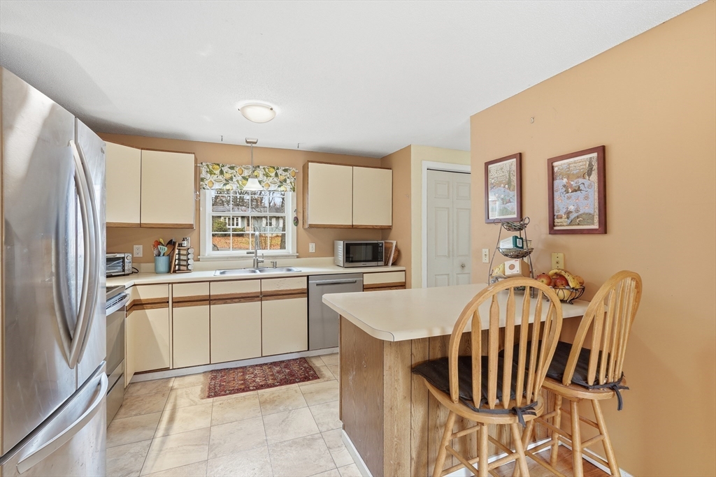 58 A Laurel Street, Unit 58A Greenfield, MA 01301 - Photo 10 of 35 a kitchen with granite countertop a sink stove and refrigerator