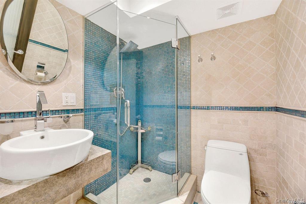 109-33 71st Road, Unit 11A Queens, NY 11375 - Photo 16 of 21 a bathroom with a toilet sink and shower