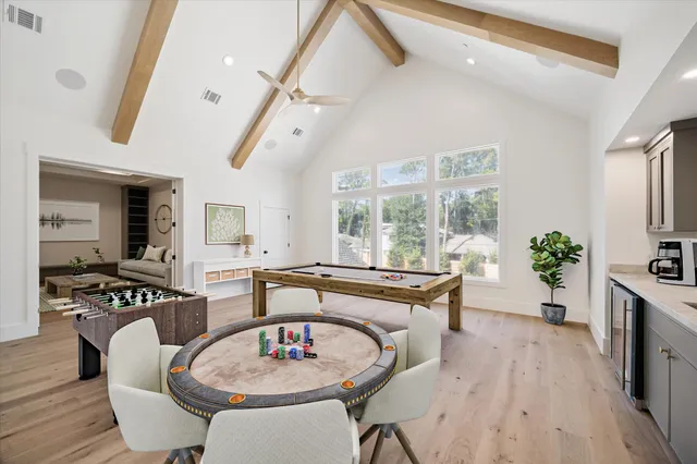 a kitchen with white cabinets and window