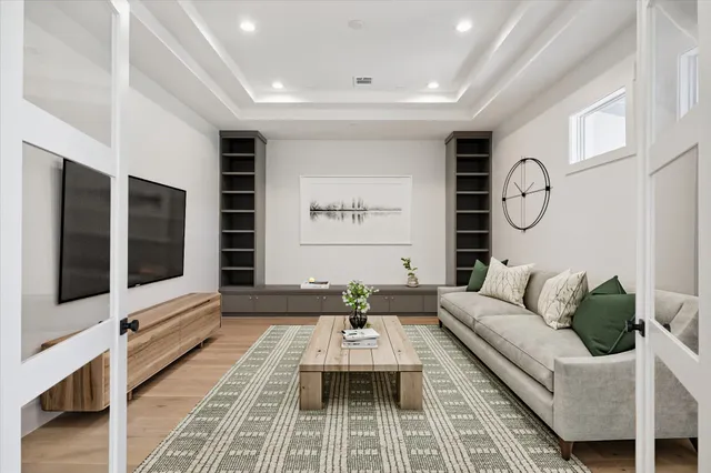 a view of an empty room with a window and kitchen view