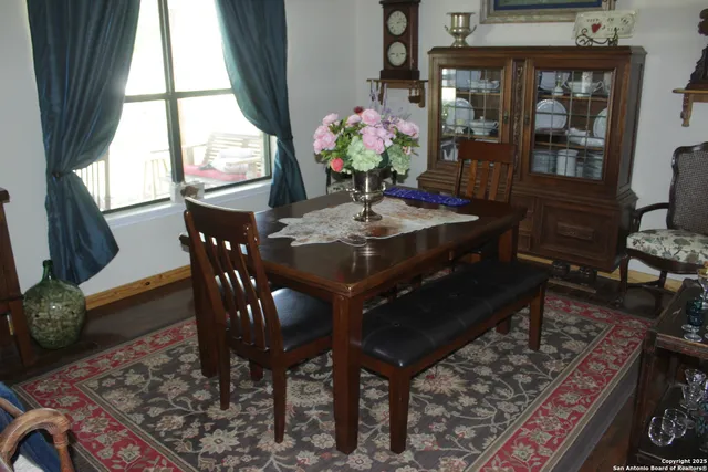 a view of a dining room with furniture and window