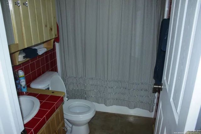 a bathroom with a toilet and a sink
