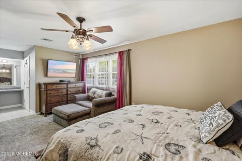 a bedroom with bed and window