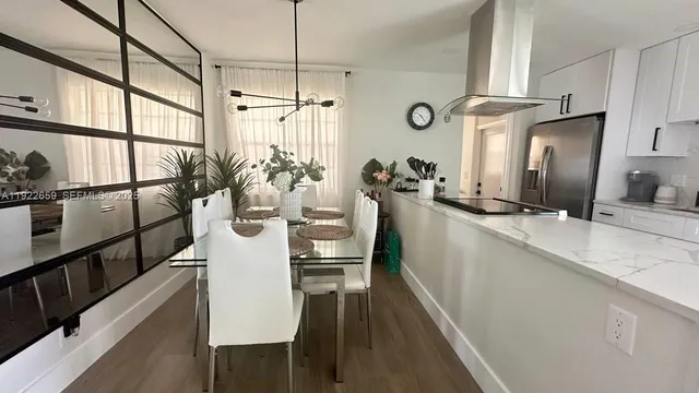 a kitchen with sink refrigerator and microwave