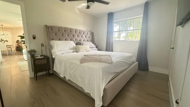 a bed sitting in a bedroom next to a window