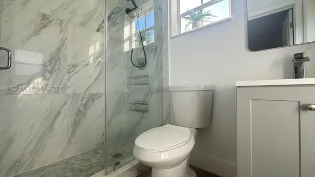 a bathroom with a toilet sink and shower