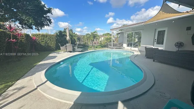 a view of a swimming pool with outdoor seating