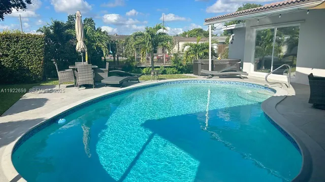 a swimming pool with outdoor seating and yard