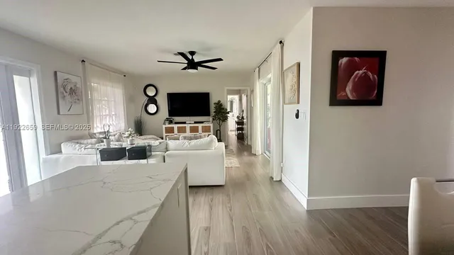 a living room with furniture wooden floor and a flat screen tv