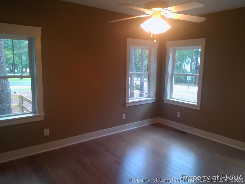 4015 Youngs Road Southern Pines, NC 28387 - Photo 12 of 25 a view of an empty room with wooden floor and a window