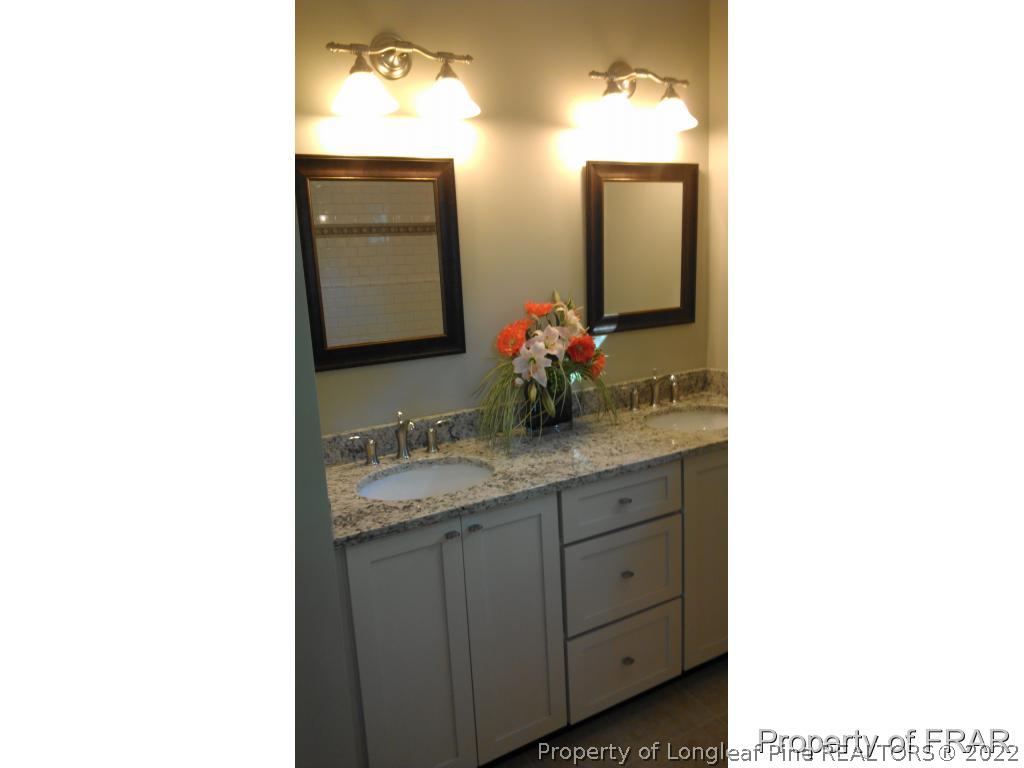 4015 Youngs Road Southern Pines, NC 28387 - Photo 18 of 25 a bathroom with a sink and a mirror