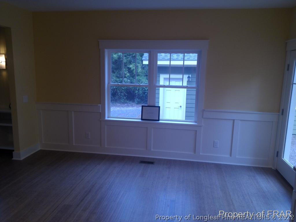4015 Youngs Road Southern Pines, NC 28387 - Photo 21 of 25 an empty room with wooden floor and windows