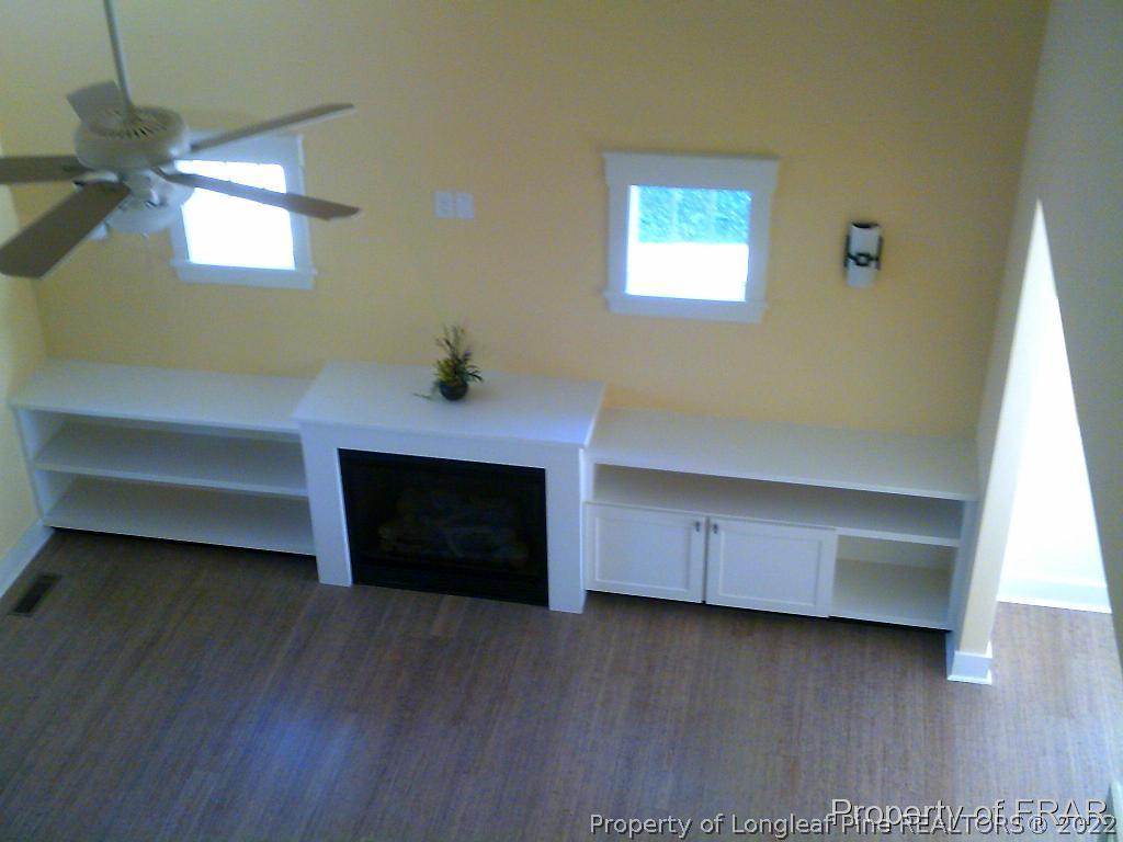 4015 Youngs Road Southern Pines, NC 28387 - Photo 8 of 25 a living room with hard wood floors and a ceiling fan