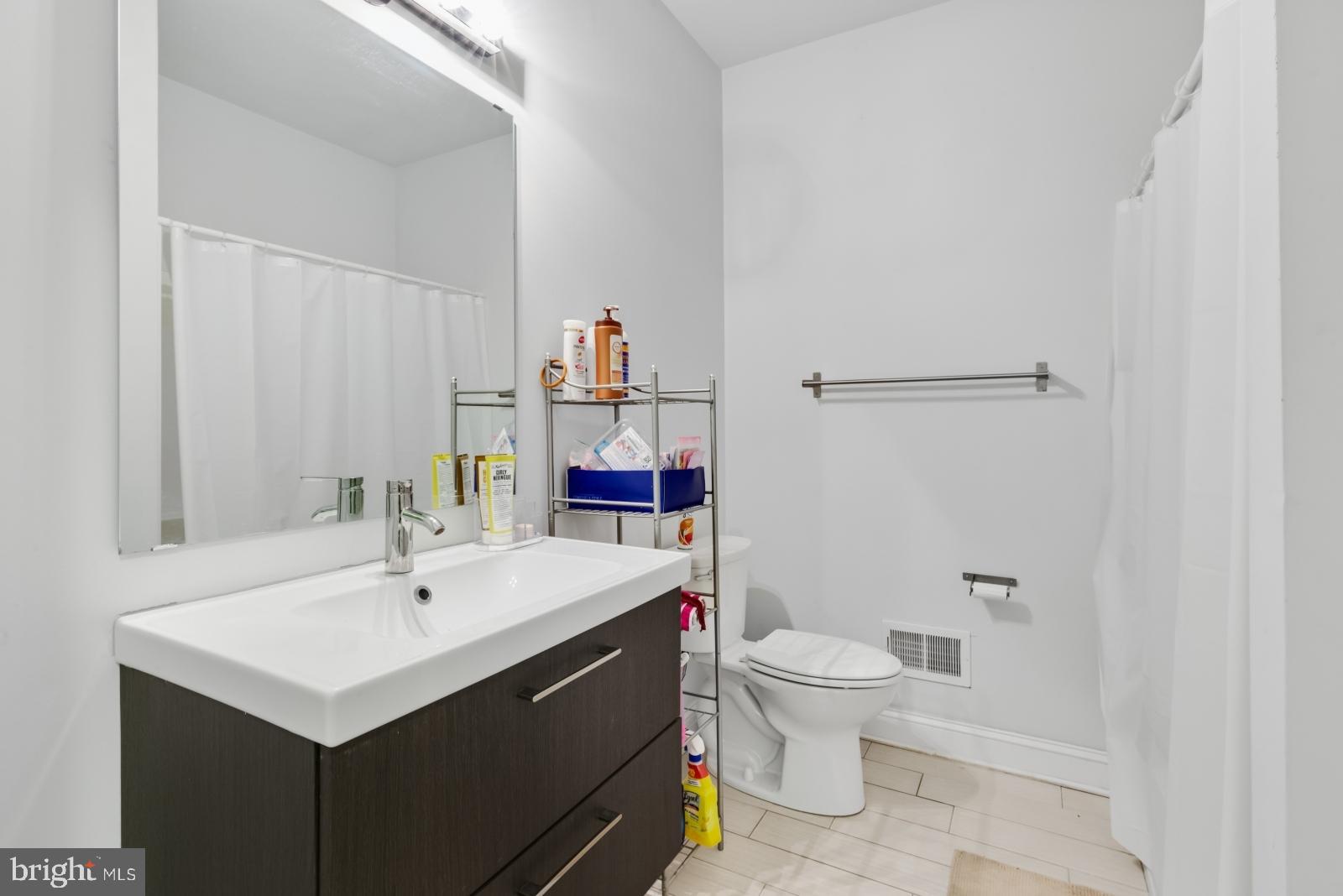 2629 Cedar Street Philadelphia, PA 19125 - Photo 19 of 30 a bathroom with a sink toilet and a mirror