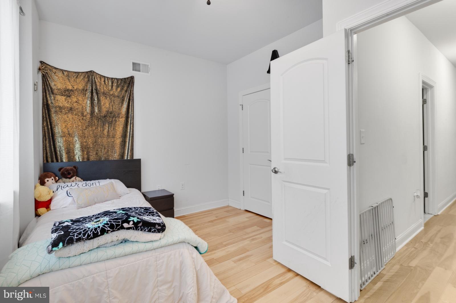 2629 Cedar Street Philadelphia, PA 19125 - Photo 21 of 30 a bedroom with a bed and a mirror