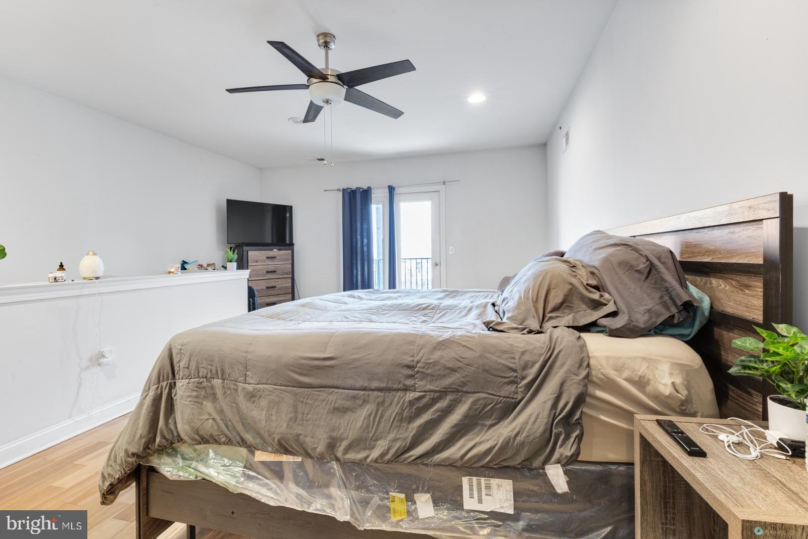 2629 Cedar Street Philadelphia, PA 19125 - Photo 24 of 30 a bedroom with a bed and a chandelier