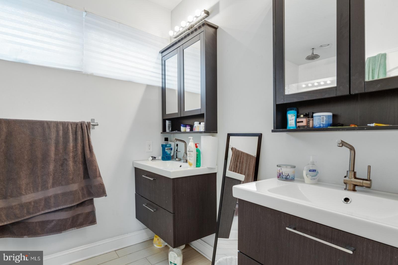 2629 Cedar Street Philadelphia, PA 19125 - Photo 27 of 30 a bathroom with a sink a toilet and mirror