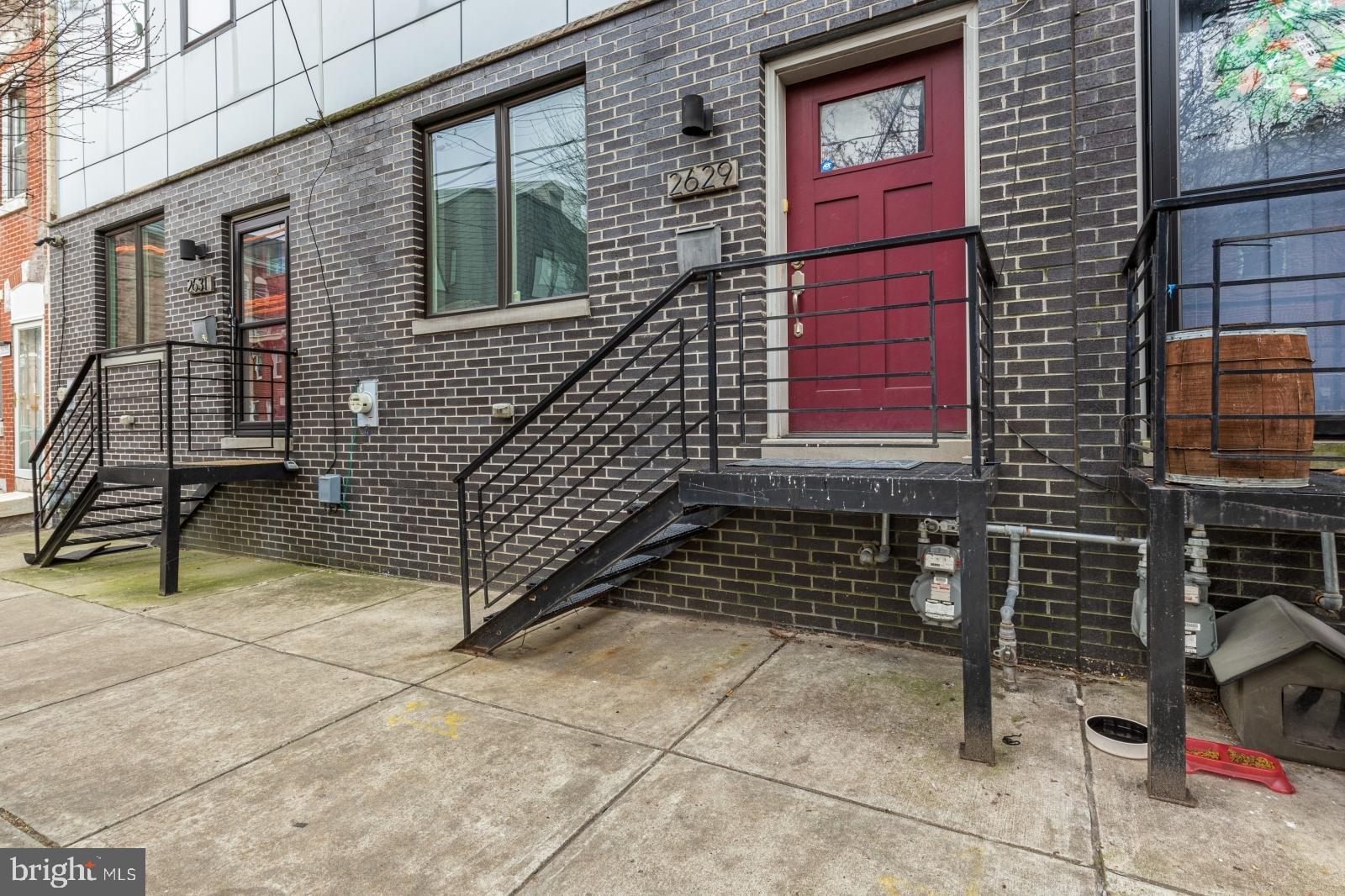 2629 Cedar Street Philadelphia, PA 19125 - Photo 29 of 30 a brick building with a bench and a window