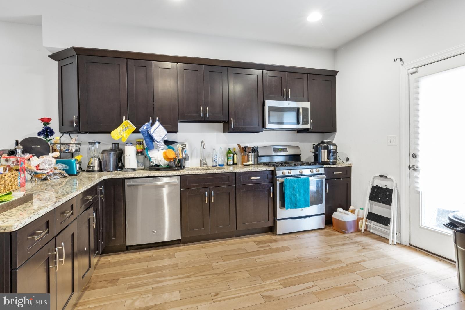 2629 Cedar Street Philadelphia, PA 19125 - Photo 6 of 30 a kitchen with stainless steel appliances a stove a sink cabinets and a refrigerator