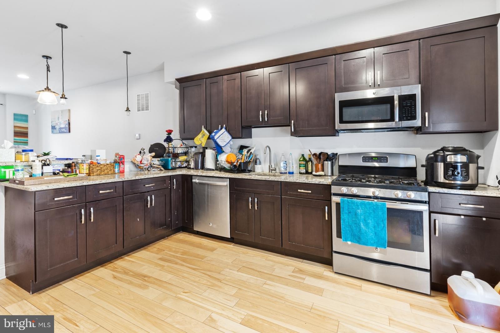2629 Cedar Street Philadelphia, PA 19125 - Photo 7 of 30 a kitchen with stainless steel appliances granite countertop a sink stove and microwave