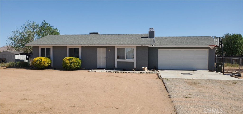 22301 Broken Lance Road Apple Valley, CA 92307 - Photo 1 of 1 a front view of a house with a yard and garage