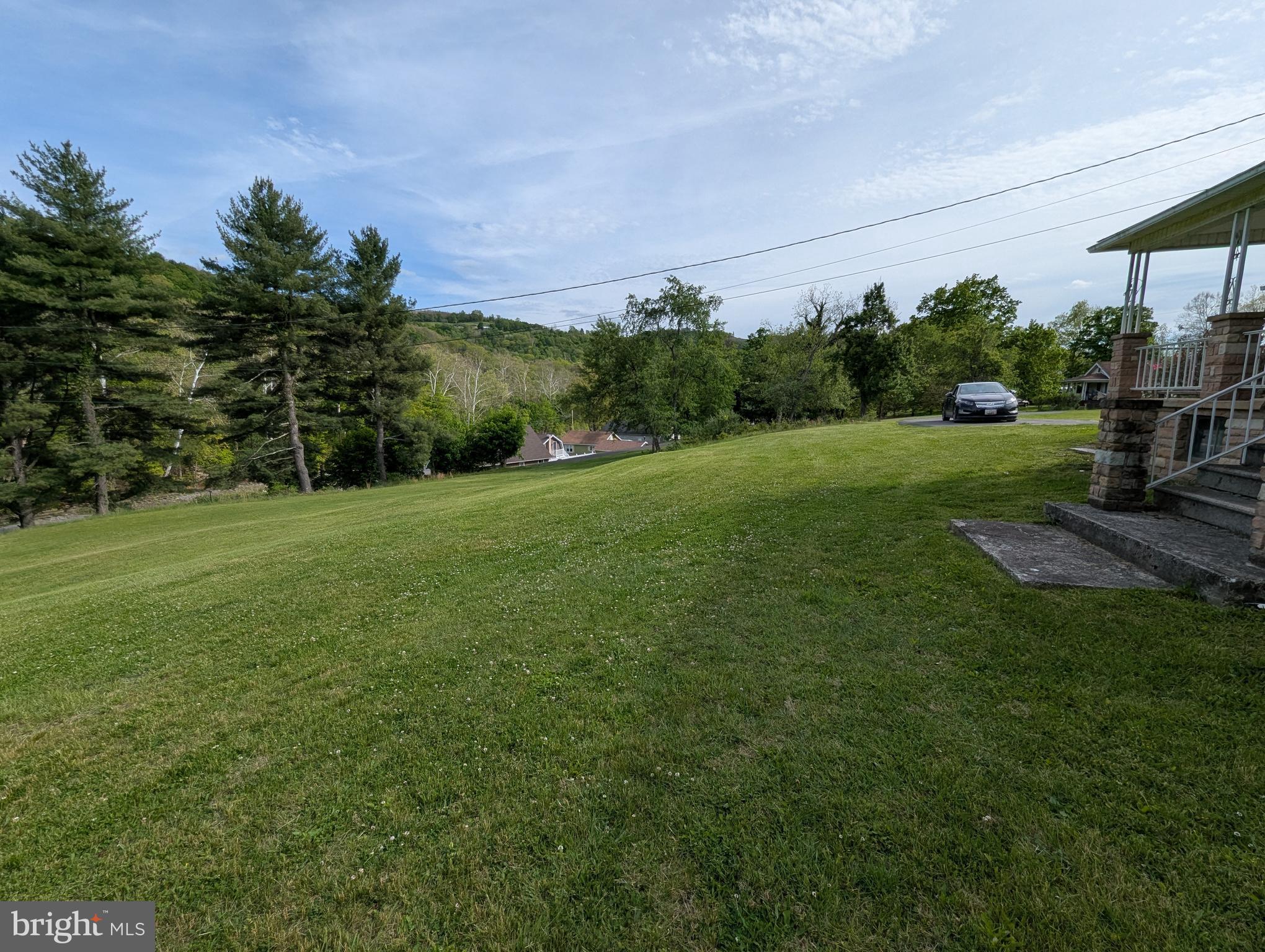 24001 Perry Hill Road Barton, MD 21521 - Photo 21 of 37 a view of a grassy field with trees in the background