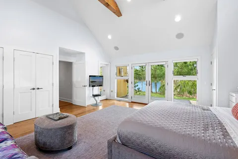 a bedroom with furniture and a large window