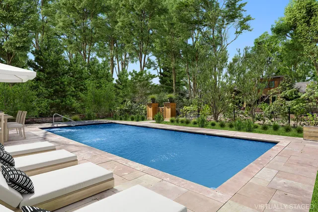 a front view of a house with a yard and trees