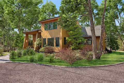 a front view of a house with a yard and a garage