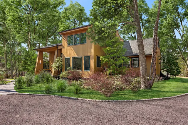 a front view of a house with a yard and a garage