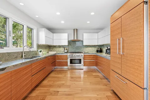 a living room with furniture fireplace and a large window