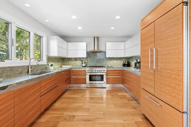 a living room with furniture fireplace and a large window