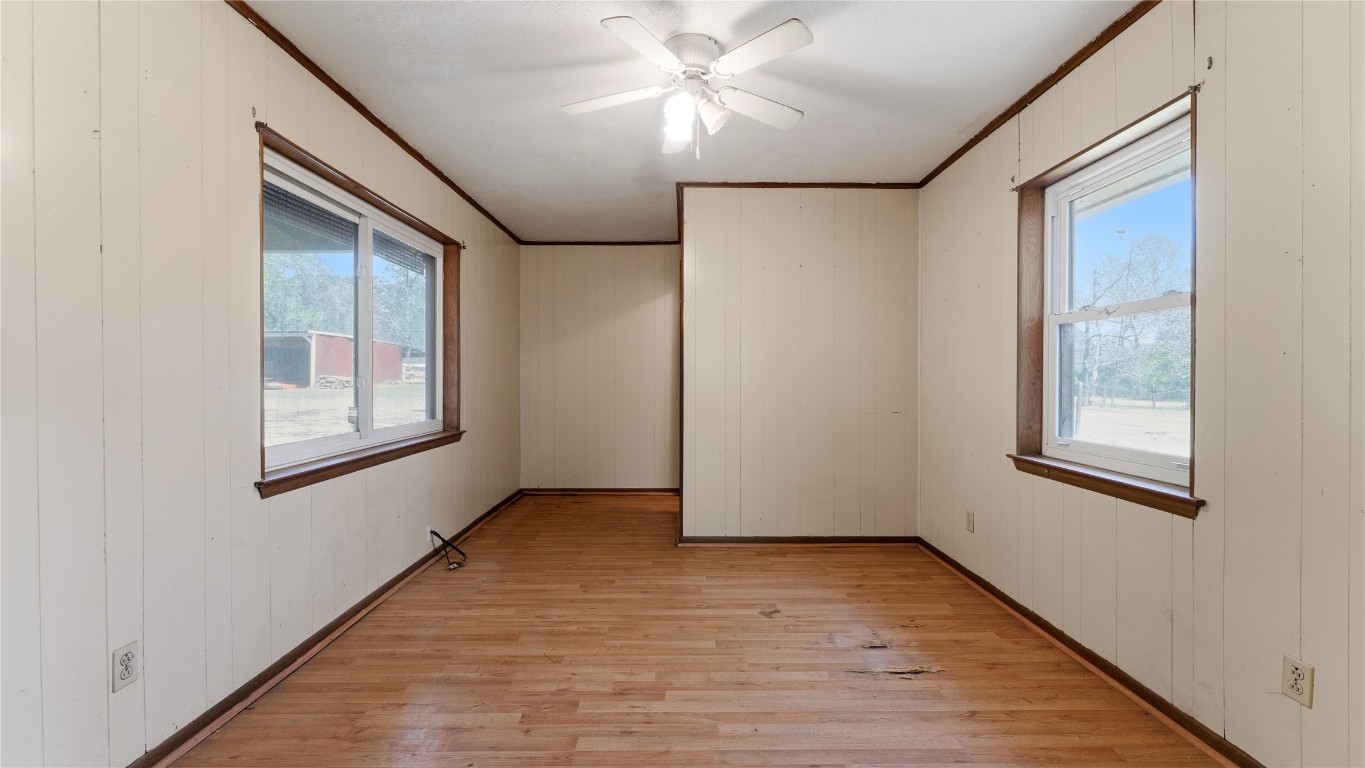 187 Watson Lake Road Huntsville, TX 77340 - Photo 18 of 25 an empty room with windows and fan